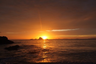 Sunrise over Awanue Rock at Ocean Beach